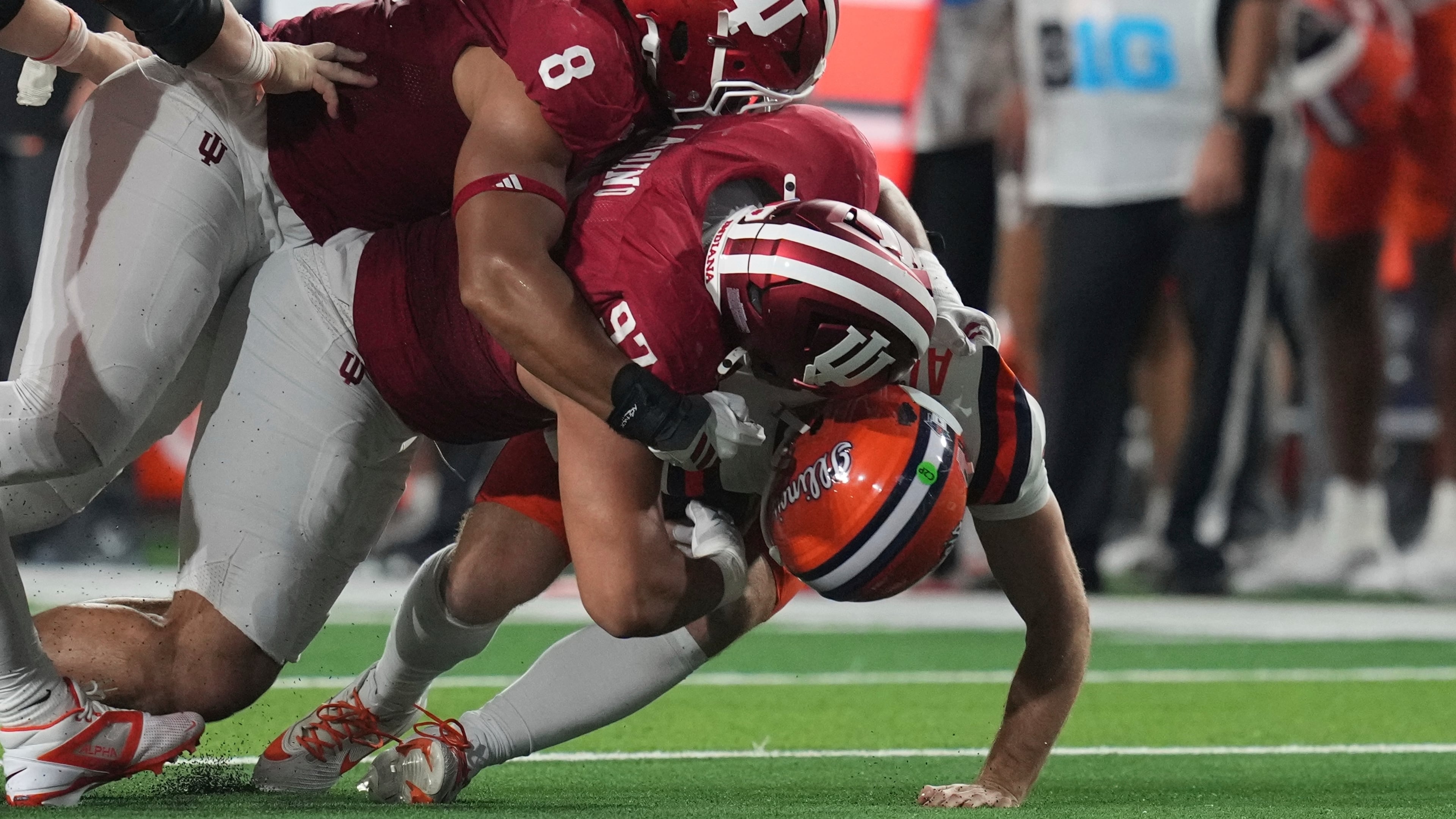 Illinois quarterback Luke Altmyer (9) is sacked by Indiana defensive lineman Stephen Daley (8)and defensive lineman Mario Landino (97) during the first half of an NCAA college football game, Saturday, Sept. 20, 2025, in Bloomington, Ind. (AP Photo/Darron Cummings)