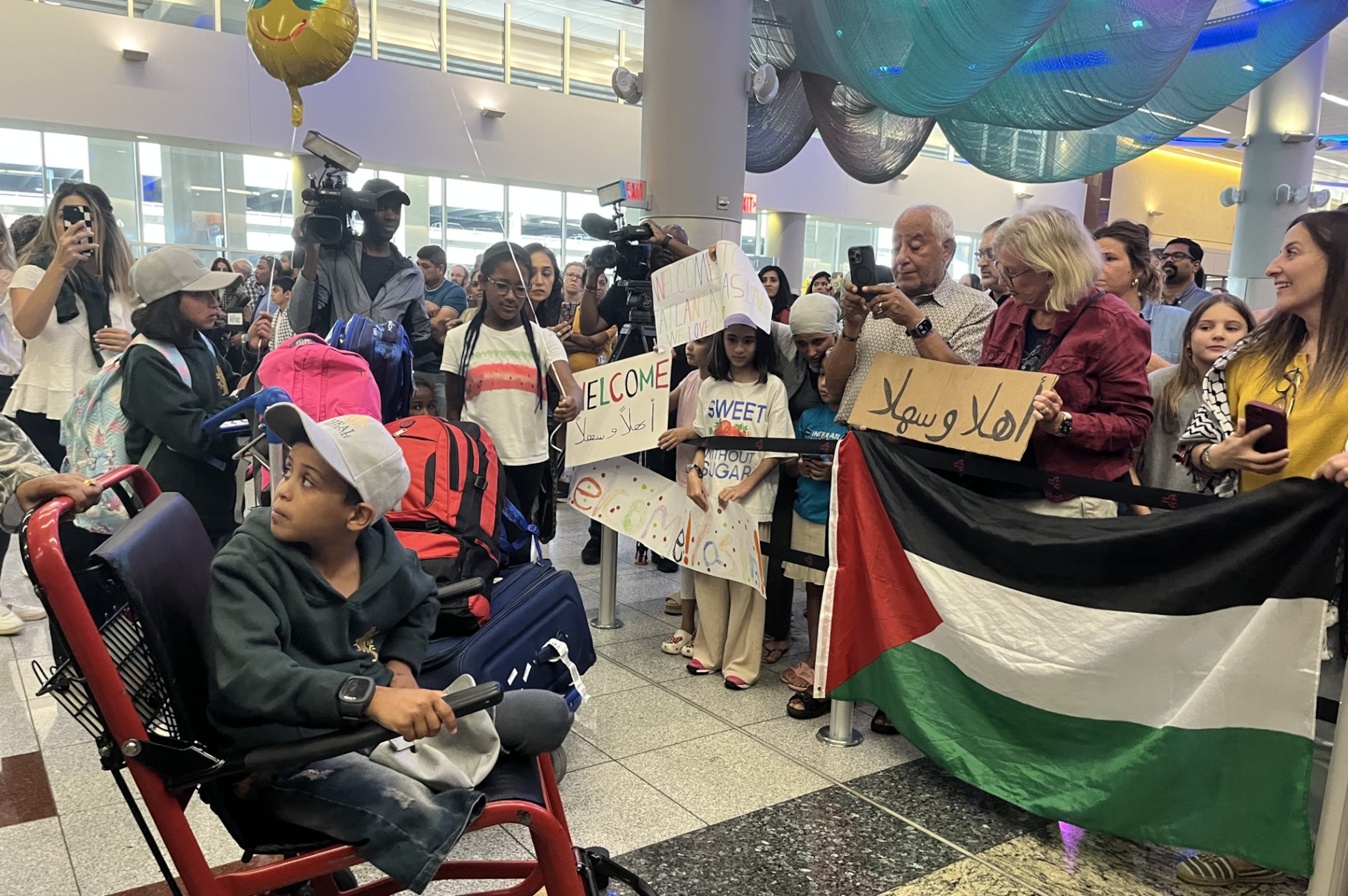 Supporters greet 12-year-old Yassin Alghalban at Hartsfield-Jackson International Airport on Sunday, Aug. 3 2025. (Safa Wahidi/AJC).