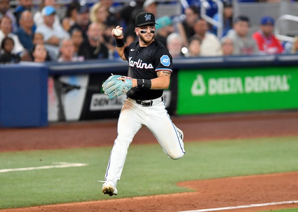Miami Marlins third baseman Connor Norby holds the ball hit by Atlanta Braves' Ronald Acuña Jr. during the fifth inning of a baseball game Friday, June 20, 2025, in Miami. (AP Photo/Michael Laughlin)