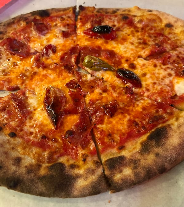 The Calabrian pizza is topped with spicy calabrese salami, Calabrian peppers and hot chili oil. It packs some heat. (Olivia Wakim/AJC)