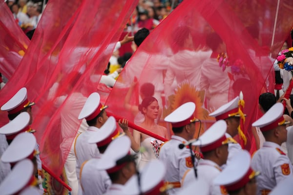 Vietnamese dancers perform during a parade celebrating the 50th anniversary of the end of the Vietnam War in Ho Chi Minh City, Vietnam, Wednesday, April 30, 2025. (AP Photo/Achmad Ibrahim)