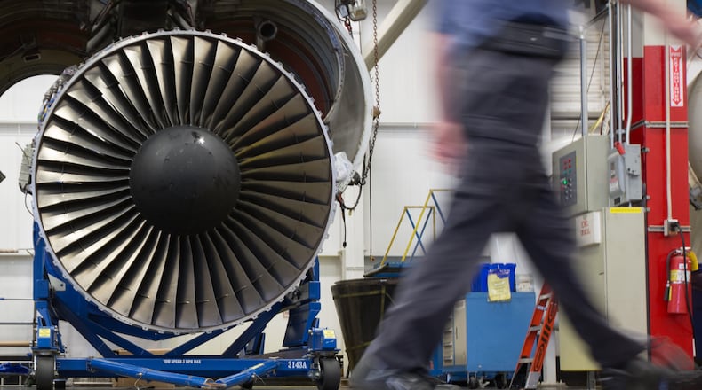 A Delta TechOps employee walks past an airplane engine inside a Delta TechOps building near Hartsfield-Jackson Atlanta International Airport, Monday, Oct. 26, 2015, in Atlanta. Delta announced a new partnership with Rolls Royce as an approved maintenance center. BRANDEN CAMP/SPECIAL