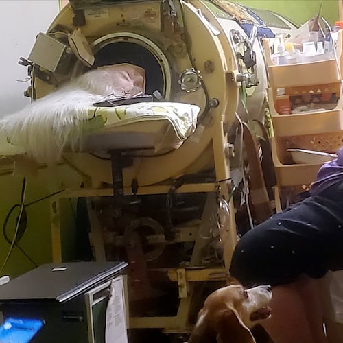 In this photo provided by Cindy McVey, her sister Martha Lillard rests in her iron lung on Friday, February 6, 2026 in Shawnee, Okla. (Cindy McVey via AP)