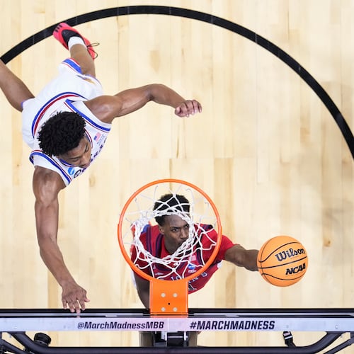St. John's guard Ian Jackson (11) shoots around Kansas forward Bryson Tiller (15) during a game in the second round of the NCAA college basketball tournament Sunday, March 22, 2026, in San Diego. (AP Photo/Mark J. Terrill)