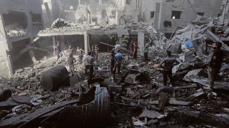 Palestinians inspect the rubble of a building, destroyed by an Israeli army strike at Al-Shati camp in Gaza City Wednesday, Oct. 29, 2025. (AP Photo/Yousef Al Zanoun)