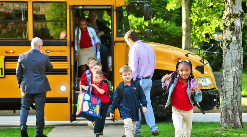 FILE - Second-grader Aaminah Ingram-Kirk, 7, leads the way off the bus for the first day of school at Bishop McCort Catholic Elementary West on Tioga Street in Johnstown, Pa., Aug. 21, 2024. (Thomas Slusser/The Tribune-Democrat via AP, File)