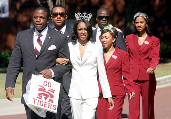 Morehouse student body president Stanley Onuoha, a senior from Boston, escorts Miss Maroon and White, Kera Street, a senior from Richmond, Virginia, as they walk to the stadium before their game in this 2007 file photo.