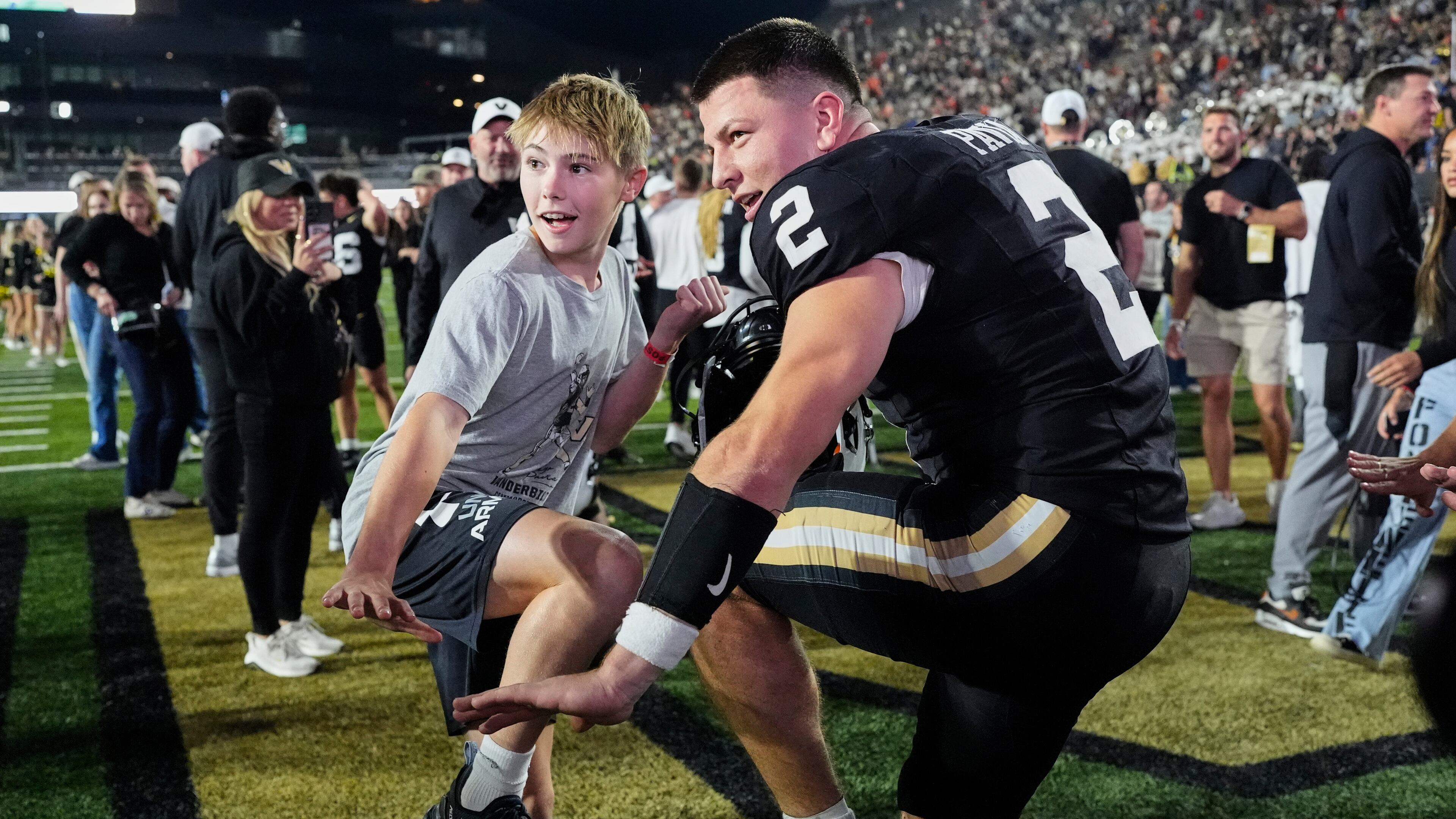 Vanderbilt quarterback Diego Pavia (2) and Xavier Swallows, left, make the Heisman pose after the team's win an NCAA college football game against Auburn, Saturday, Nov. 8, 2025, in Nashville, Tenn. (AP Photo/George Walker IV)