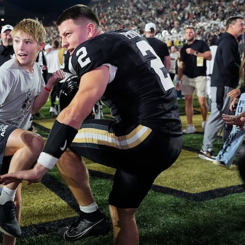 Vanderbilt quarterback Diego Pavia (2) and Xavier Swallows, left, make the Heisman pose after the team's win an NCAA college football game against Auburn, Saturday, Nov. 8, 2025, in Nashville, Tenn. (AP Photo/George Walker IV)