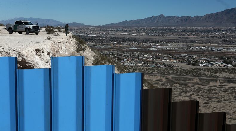 An agent of the border patrol, observes near the Mexico-US border fence, on the Mexican side, separating the towns of Anapra, Mexico and Sunland Park, New Mexico, Wednesday, Jan. 25, 2017. U.S. President Donald Trump says his administration will be working in partnership in Mexico to improve safety and economic opportunity for both countries and will have "close coordination" with Mexico to address drug smuggling. It will set in motion the construction of his proposed border wall, a key promise from his 2016 campaign. (AP Photo/Christian Torres)