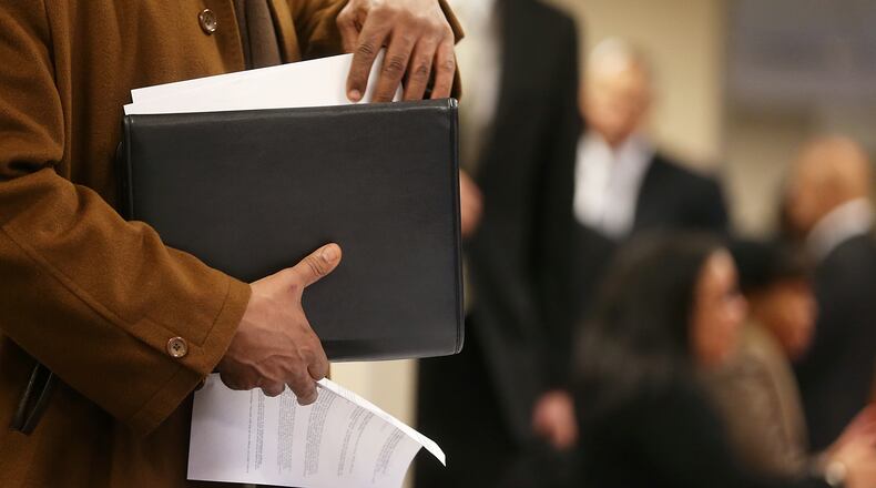 An applicant goes through paperwork at a job fair on Jan. 17, 2013. (Getty Images)