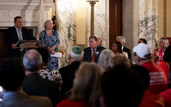 Rhode Island House Speaker K. Joseph Shekarchi, left, addresses a crowd gathered to witness Gov. Dan McKee sign a bill that bans the sale of assault-style weapons in the state of Rhode Island at the Rhode Island Statehouse in Providence, Thursday, June 26, 2025. (AP Photo/Sydney Roth)