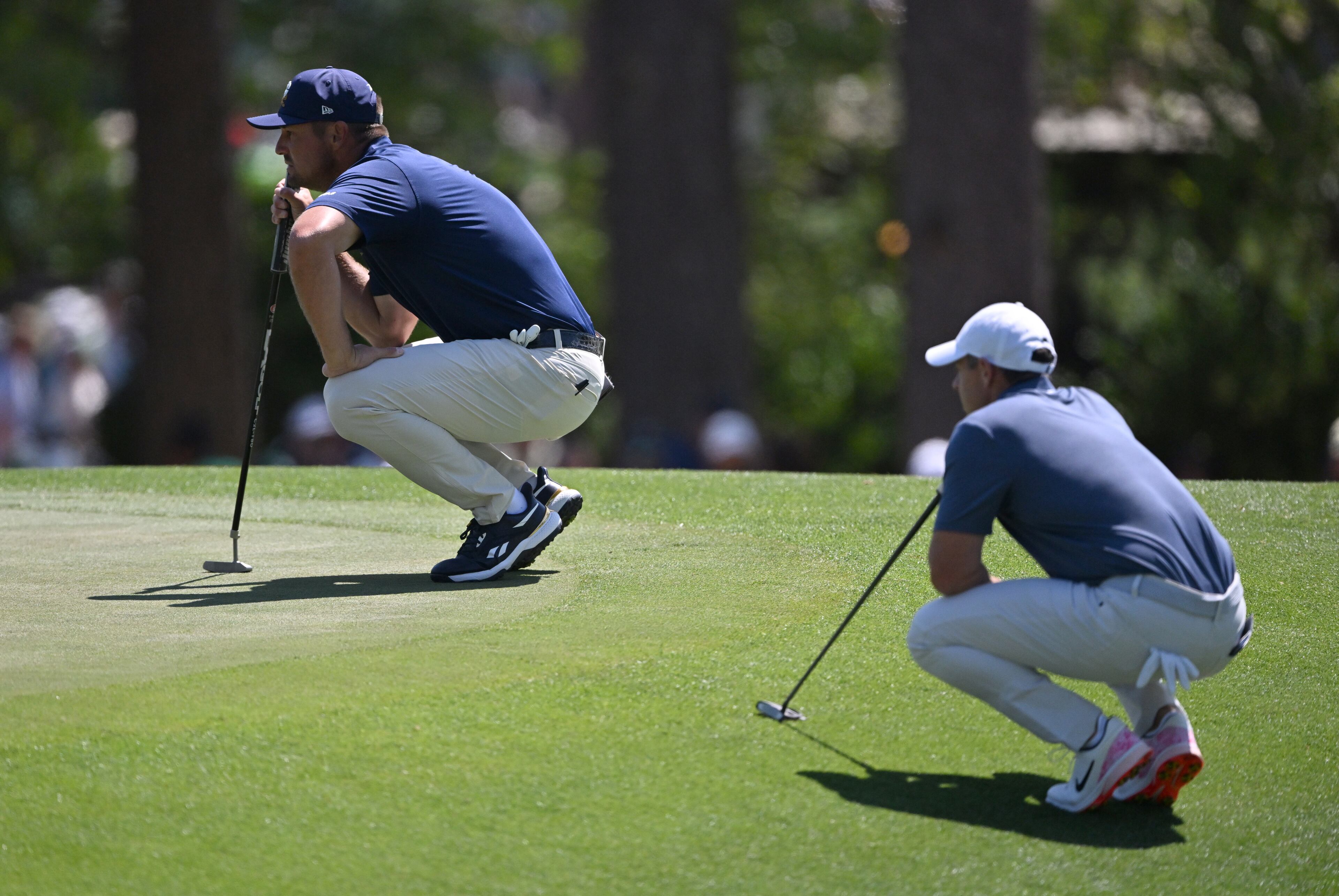 Bryson DeChambeau left and Rory McIlroy check the third green during final round of the Masters golf tournament, at Augusta National Golf Club, Saturday, April 13, 2025, in Augusta, Ga. (Hyosub Shin / AJC)