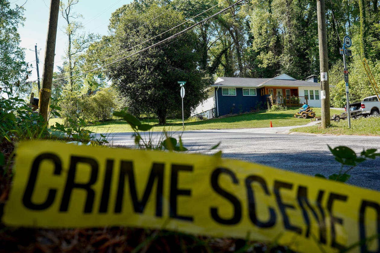 Only police tape remained on the street where Lauren Bullis, a U.S. Department of Homeland Security employee, was killed while walking her dog April 13, 2026. The shooting suspect, Olaolukitan Adon Abel, died in custody Tuesday, the DeKalb County Sheriff's Office says. (Ben Hendren for the AJC)