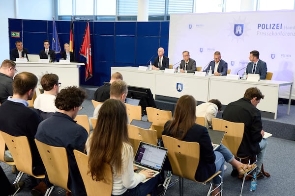 From right, Head of the State Office of Criminal Investigation Jan Hieber, Chief of Police Falk Schnabel and Chief Public Prosecutor Joerg Froehlich give a press conference by the police and Chief Public Prosecutor at police headquarters after a 20-year-old was arrested on suspicion of murdering a child, in Hamburg, Germany, Wednesday, June 18, 2025. (Georg Wendt/dpa via AP)