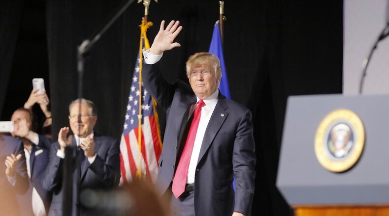 President Donald Trump waves to the crowd at the Georgia World Congress Center in Atlanta after his speech Friday. BOB ANDRES / BANDRES@AJC.COM