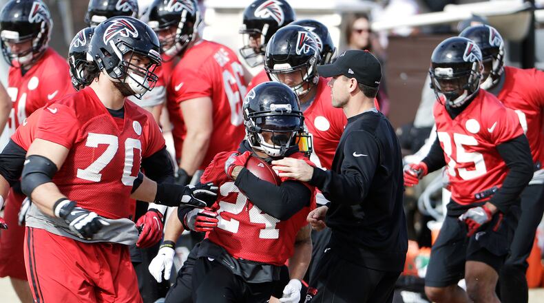 Atlanta Falcons running back Devonta Freeman (24) runs through a drill during a workout at the football team's practice facility in Flowery Branch, Ga., Wednesday, Jan. 25, 2017. (AP Photo/David Goldman)