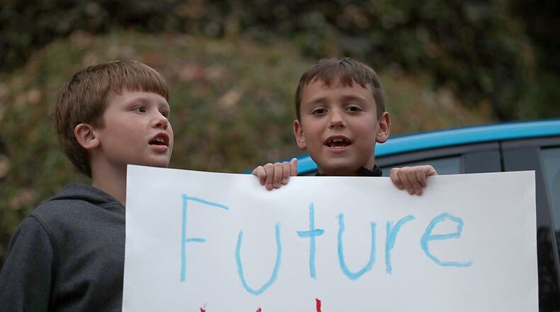 PIEDMONT, CA - AUGUST 23: Young supporterts hold a sign outside of a fundraiser for democratic presidential nominee former Secretary of State Hillary Clinton on August 23, 2016 in Piedmont, California. Hillary Clinton is attending fundraisers in California. (Photo by Justin Sullivan/Getty Images)
