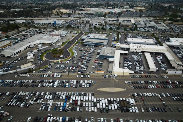 An aerial view shows auto dealerships in Cerritos, Calif., Thursday, March 27, 2025. (AP Photo/Jae C. Hong)