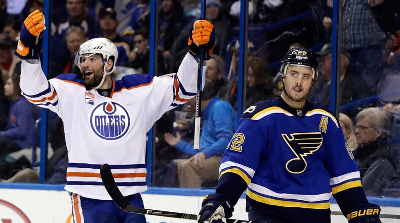 Edmonton Oilers' Patrick Maroon, left, celebrates after scoring as St. Louis Blues' Kevin Shattenkirk skates past during the third period of an NHL hockey game, Monday, Dec. 19, 2016, in St. Louis. The Oilers won 3-2 in overtime.
