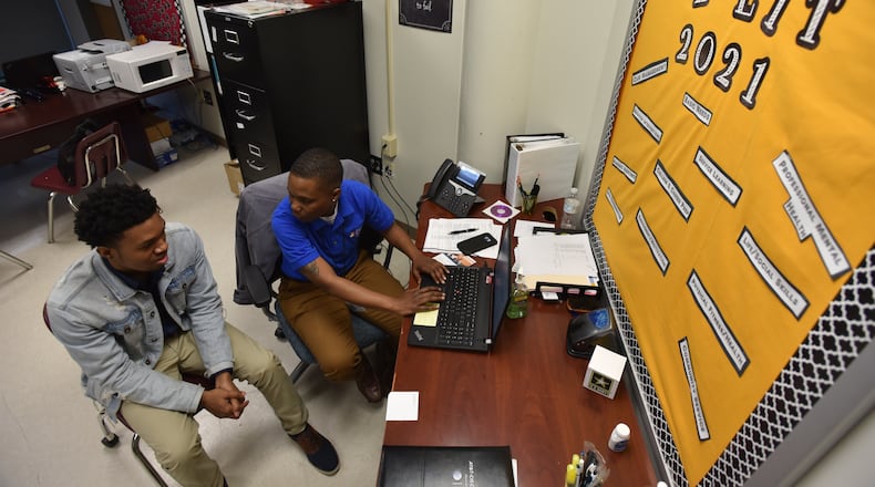 Valencia Dennis, student support coach, talks to Paul Askew, 17, during their Target 2021 program session at Maynard Jackson High School on Wednesday, February 7, 2018. HYOSUB SHIN / HSHIN@AJC.COM
