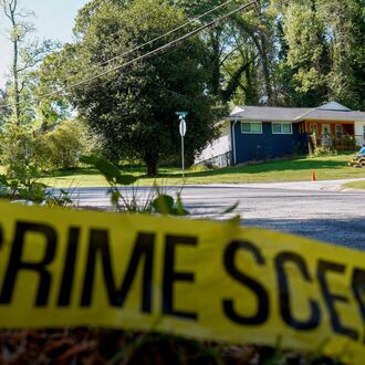 Only police tape remained on the street where Lauren Bullis, a U.S. Department of Homeland Security employee, was killed while walking her dog April 13, 2026. The accused suspect, Olaolukitan Adon Abel, now faces a federal firearms charge.(Ben Hendren for the AJC)
