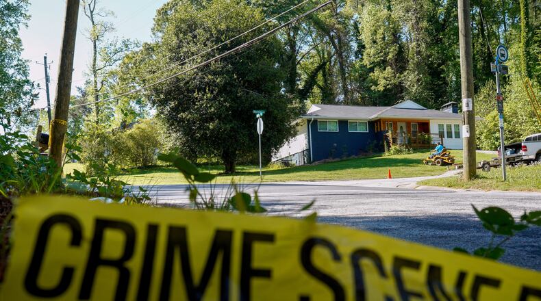 Only police tape remained on the street where Lauren Bullis, a U.S. Department of Homeland Security employee, was killed while walking her dog April 13, 2026. The accused suspect, Olaolukitan Adon Abel, now faces a federal firearms charge.(Ben Hendren for the AJC)
