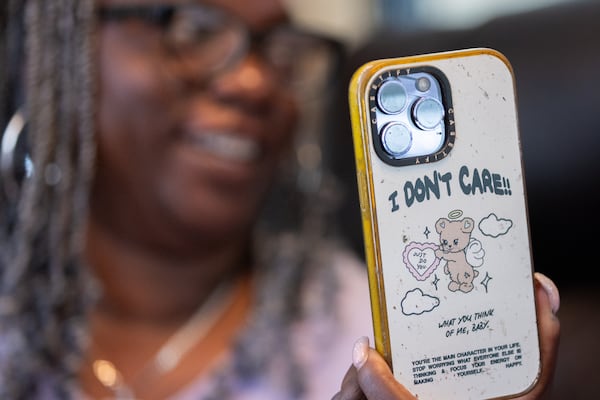Oneida Oliver-Sanders, mother of Army Reserve Sgt. Kennedy L. Sanders, shows her daughter’s phone at her home in Waycross on May 16, 2025. Kennedy Sanders was killed last year in a drone strike in Jordan, and a fellow service member found the phone, tracked down Sanders' parents and was able to send them the phone. (Arvin Temkar/AJC)