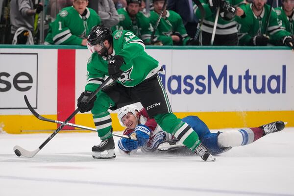 Dallas Stars center Colin Blackwell (15) skates away from the puck after taking it from Colorado Avalanche center Martin Necas during the first period in Game 2 of a first-round NHL hockey playoff series Monday, April 21, 2025, in Dallas. (AP Photo/Julio Cortez)