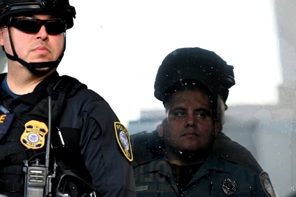FILE - A DHS officer stands guard outside the Robert Young Federal Building during a march in solidarity for a peaceful interfaith Prayer Walk for Family Unity, June 18, 2025, in Los Angeles. (AP Photo/Wally Skalij, file)