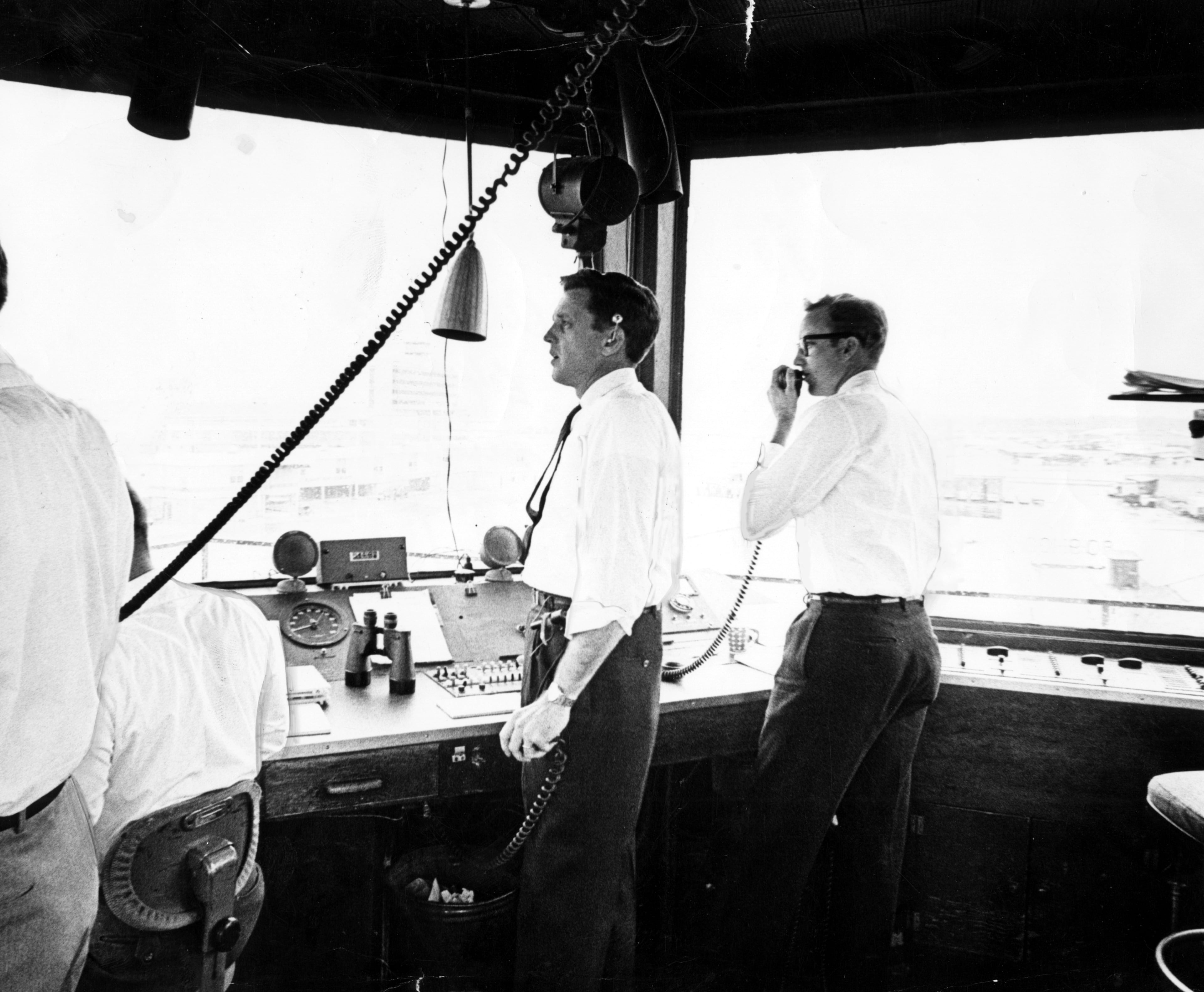 March, 1961 - Atlanta, Ga: - In the old control tower at Atlanta Airport these men have great responsibility. It's their job to handle air traffic in and out of the field without endangering the lives of those in the planes.