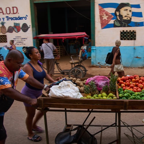 Street vendors push their cart of vegetables past a mural of Fidel Castro in Havana, Cuba, Wednesday, Aug. 12, 2026. (AP Photo/Ramon Espinosa)