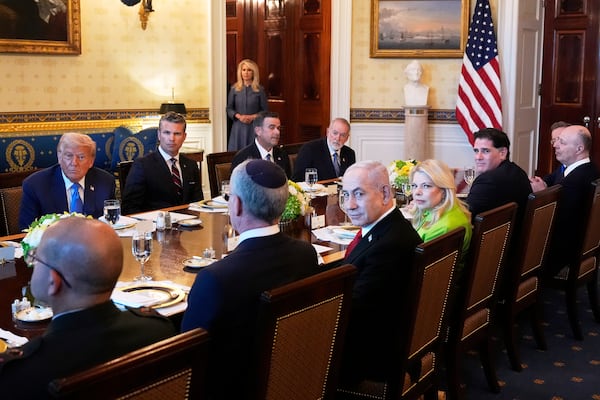 President Donald Trump, from back row left, Defense Secretary Pete Hegseth, CIA Director John Ratcliffe and U.S. Ambassador to Israel Mike Huckabee, meet with Israeli Ambassador to the U.S. Yechiel Leiter, front row from second left, Israel's Prime Minister Benjamin Netanyahu, Netanyahu's wife Sara Netanyahu, Israel's Strategic Affairs Minister Ron Dermer, Israel's National Security Council head Tzachi Hanegbi and Israel's Cabinet Secretary Yossi Fuchs in the Blue Room of the White House, Monday, July 7, 2025, in Washington. (AP Photo/Alex Brandon)