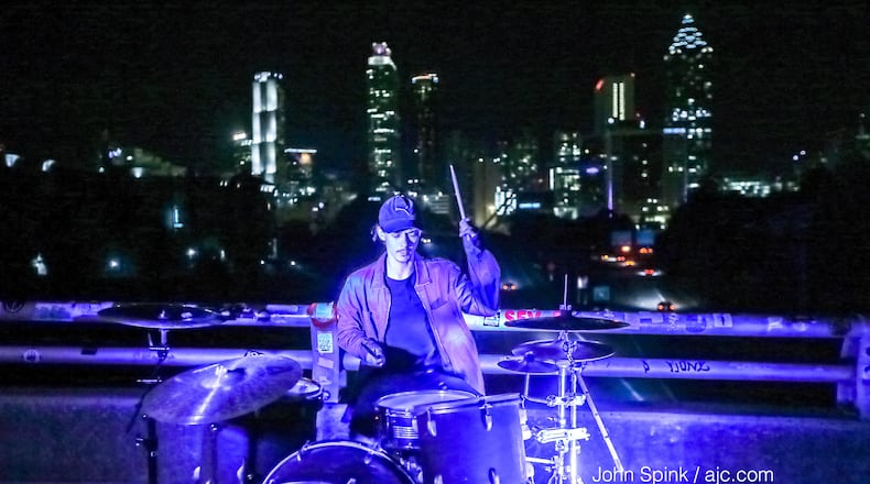 Damien Allen of Sleeping Bear drumming through the morning rush hour on the Jackson Street Bridge earlier this week.