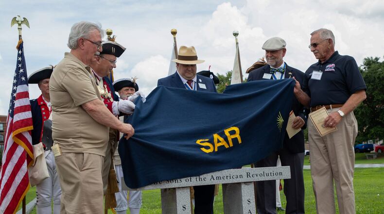 The Georgia Sons of American Revolution Leadership unveils a granite bench on July 14, 2022 at Savannah's Tricentennial Park. The chapter has worked for two years to erect the bench.