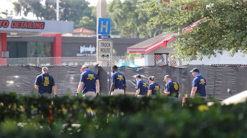 FBI investigators process the scene near Pulse nightclub in Orlando. AJC photos: Curtis Compton