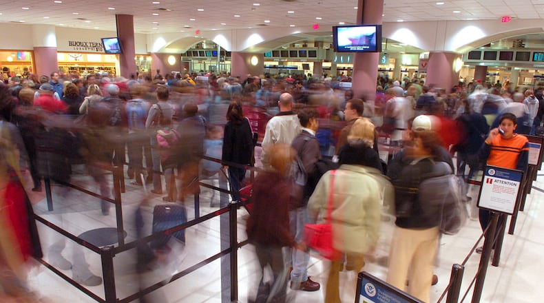 Passengers file through the security checkpoint at Hartsfield-Jackson International Airport in Atlanta, the day before Thanksgiving, the busiest travel day of year. (Photo by Chris Rank/Corbis via Getty Images)