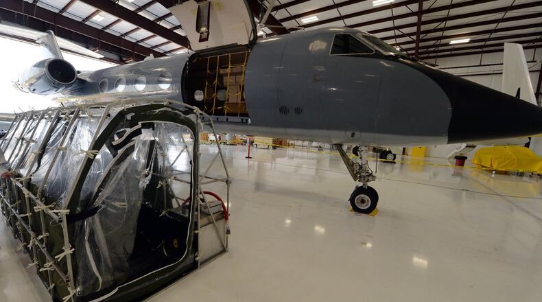 Phoenix Air’s Aeromedical Biological Containment System sits alongside the Gulfstream G3 aircraft that made both flights to Liberia. The containment pod in the photo is a test unit; the actual units used to fly the Ebola patients were incincerated after a single use. KENT D. JOHNSON/KDJOHNSON@AJC.COM