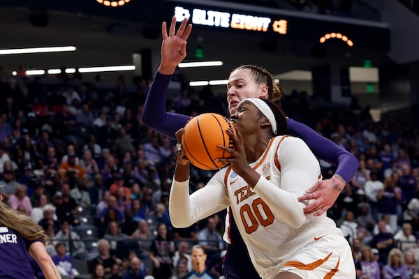 Texas forward Kyla Oldacre (00) drives to the basket around TCU center Sedona Prince (13) during the second half in the Elite Eight of the NCAA college basketball tournament, Monday, March 31, 2025, in Birmingham, Ala. (AP Photo/Butch Dill)
