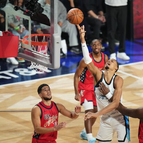 World center Victor Wembanyama, of France, shoots over USA Stars guard Devin Booker, left, and forward Jalen Duren during the NBA All-Star basketball game Sunday, Feb. 15, 2026, in Inglewood, Calif. (AP Photo/Jae C. Hong)