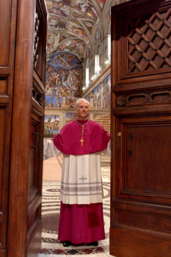 FILE - Master of Liturgical Celebrations Archbishop Piero Marini closes the door of the Sistine Chapel at the Vatican, after proclaiming the "extra omnes", which is the Latin order for all those not taking part in the conclave to leave the chapel, at the beginning of the conclave, on April 18, 2005. (Osservatore Romano via AP, File)