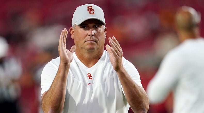 Southern California head coach Clay Helton watches warm ups on the field before an NCAA college football game against Stanford Saturday, Sept. 11, 2021, in Los Angeles. (AP Photo/Marcio Jose Sanchez)