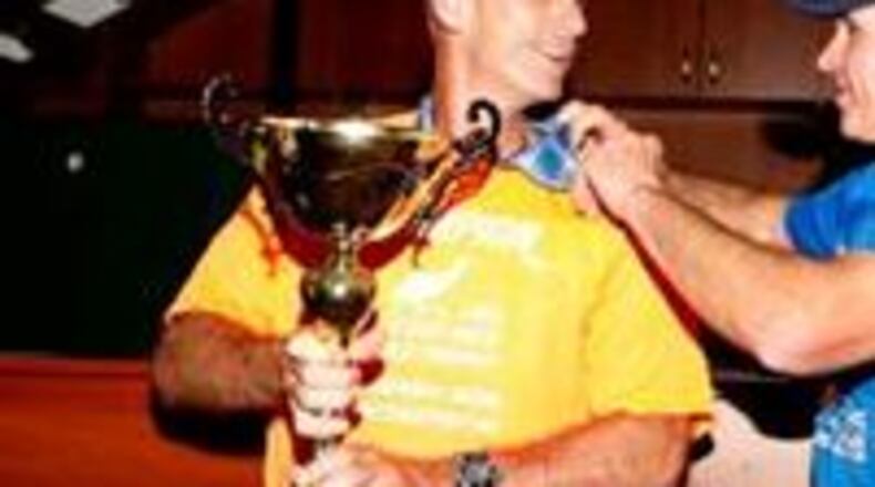 Joe Fejes holds championship trophy (emu 6 Day Ultramarathon)