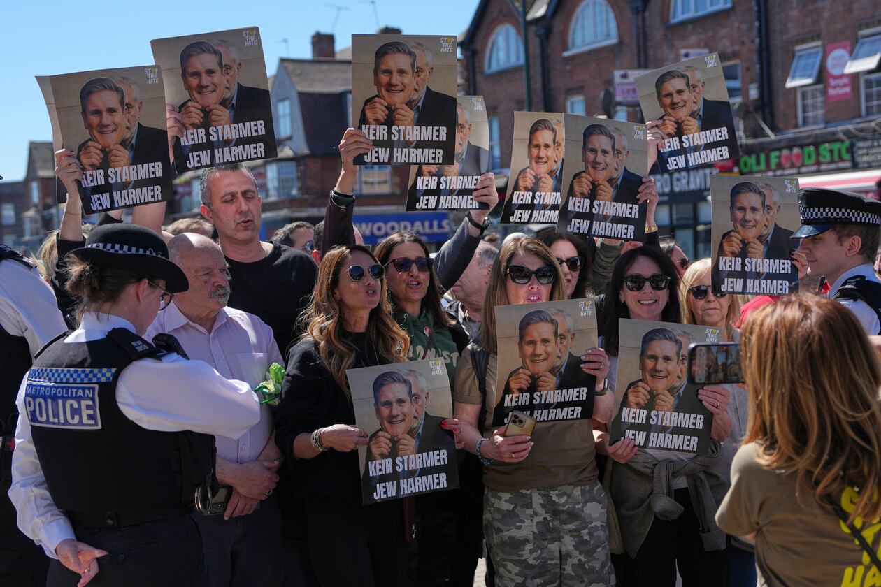 Protesters hold posters near the scene where two people were stabbed yesterday in the Golders Green neighbourhood, that has a large Jewish community, in London, Thursday, April 30, 2026.(AP Photo/Alastair Grant)