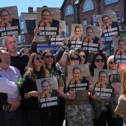 Protesters hold posters near the scene where two people were stabbed yesterday in the Golders Green neighbourhood, that has a large Jewish community, in London, Thursday, April 30, 2026.(AP Photo/Alastair Grant)