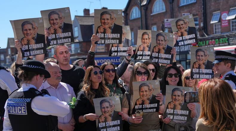 Protesters hold posters near the scene where two people were stabbed yesterday in the Golders Green neighbourhood, that has a large Jewish community, in London, Thursday, April 30, 2026.(AP Photo/Alastair Grant)