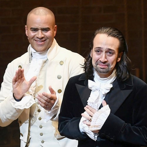 FILE - Lin-Manuel Miranda, right, takes his final performance curtain call with cast member Christopher Jackson after a performance of "Hamilton" in New York on July 9, 2016. (Photo by Evan Agostini/Invision/AP, File)