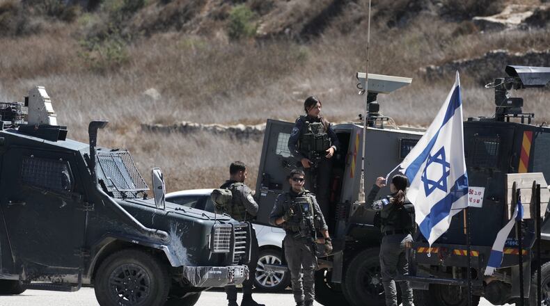 Members of the Israeli forces stand guard near the site of a shooting attack that, according to Israeli officials, killed one Israeli near the settlement of Neve Tzuf, north of the West Bank city of Ramallah, Sunday, Sept. 20, 2026. (AP Photo/Mahmoud Illean)
