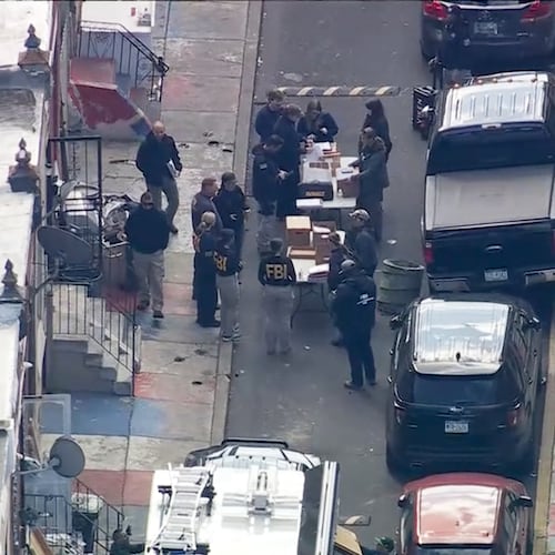 FBI agents are outside a building after a raid in the Kensington section of Philadelphia on Friday, Oct. 24, 2025. (WPVI via AP)