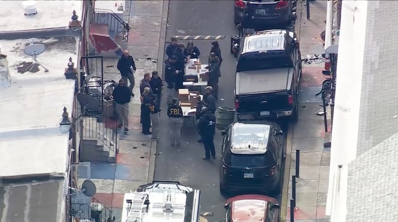 FBI agents are outside a building after a raid in the Kensington section of Philadelphia on Friday, Oct. 24, 2025. (WPVI via AP)